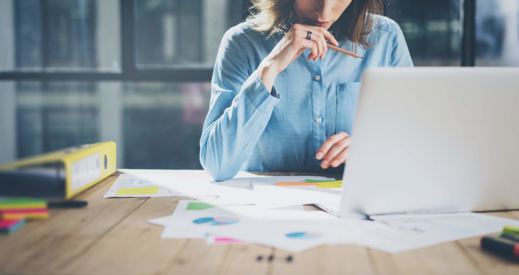 A health and nutrition coach works on her business plan and marketing niche.